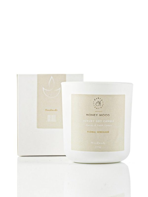 Honey and fresh cotton scented soy candle in a glass jar