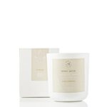 Honey and green tea scented soy candle in a glass jar