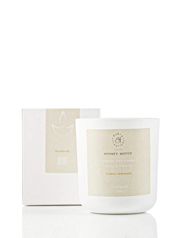 Honey and green tea scented soy candle in a glass jar
