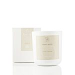 Honey and jasmine scented soy candle in a glass jar