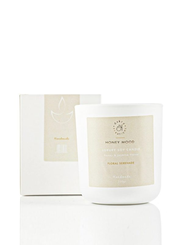 Honey and jasmine scented soy candle in a glass jar