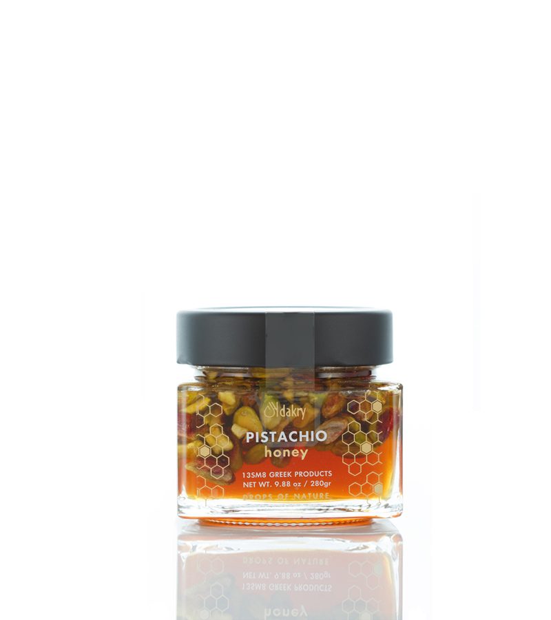 Greek orange blossom honey jar with whole Aegina pistachios