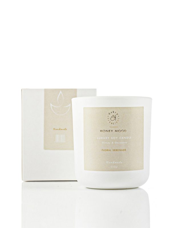 Honey and gardenia scented soy candle in a glass jar
