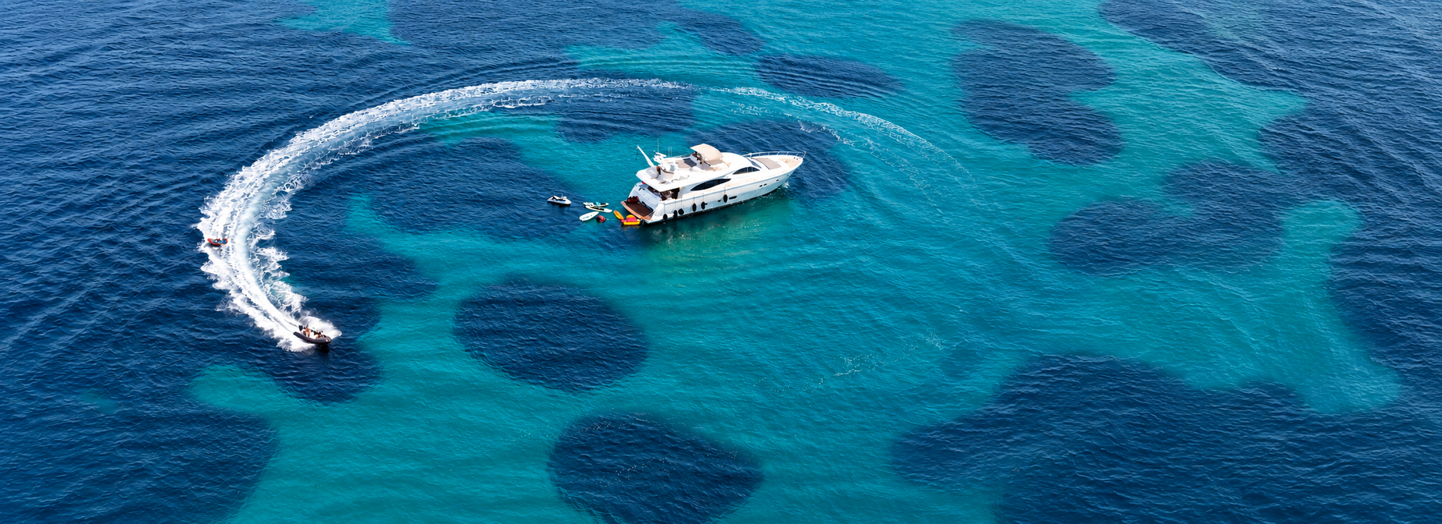 Luxury yacht anchored in turquoise Greek waters